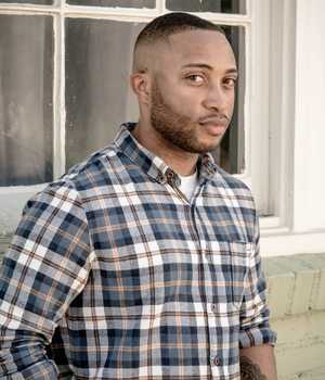 Model in checkered cotton shirt with multiple blues, yellow, and white