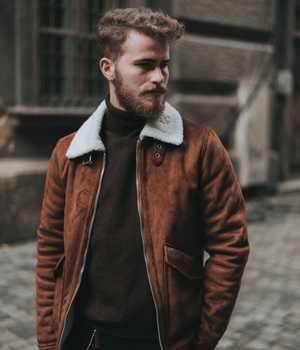 Model in leather coat with white woolen turn-down collar and two large pockets on both sides